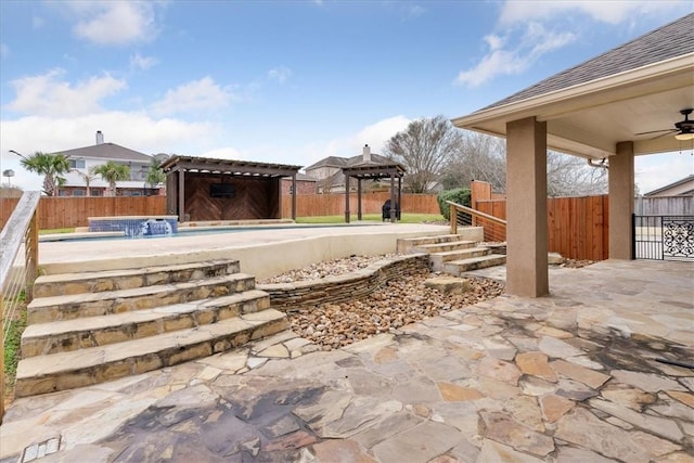 exterior space featuring a fenced in pool, a fenced backyard, ceiling fan, and a gazebo