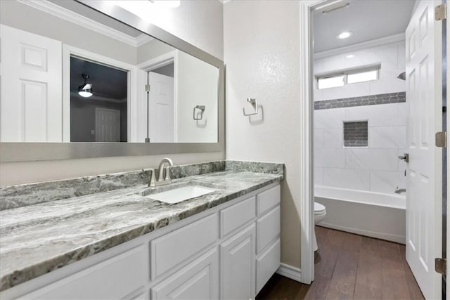 full bathroom featuring crown molding, shower / bathing tub combination, toilet, vanity, and wood finished floors