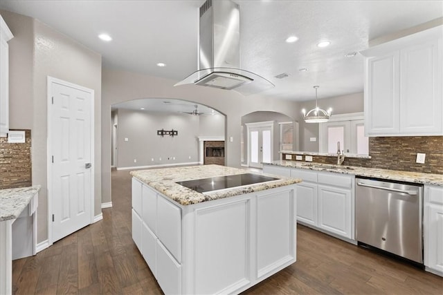 kitchen featuring arched walkways, decorative backsplash, dishwasher, wall chimney exhaust hood, and black electric stovetop