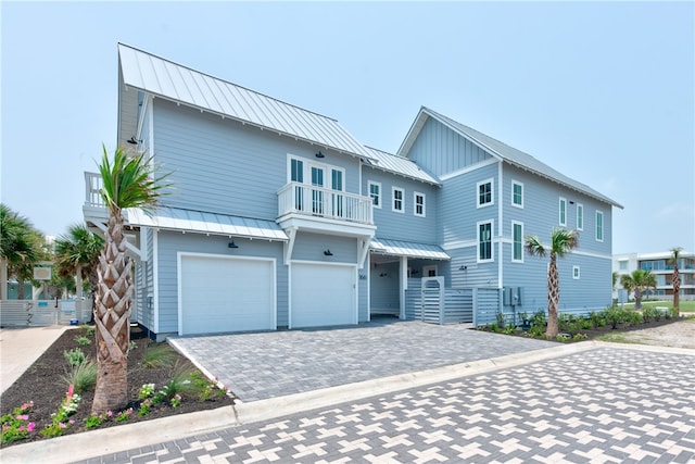 view of front of property with a balcony and a garage