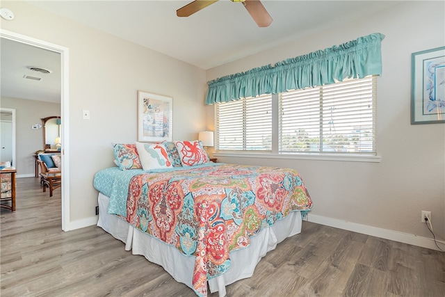 bedroom featuring wood-type flooring and ceiling fan