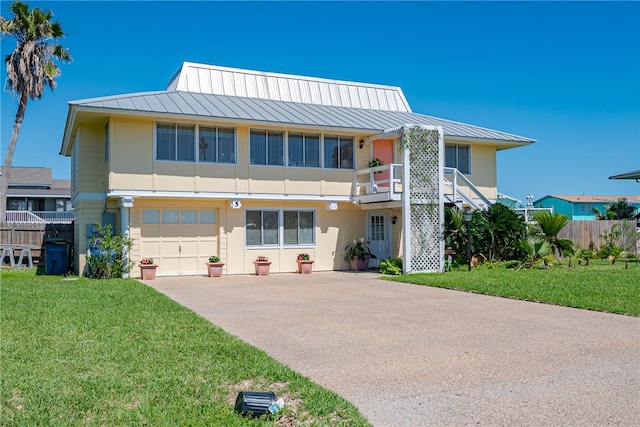 view of front of house with a garage and a front yard