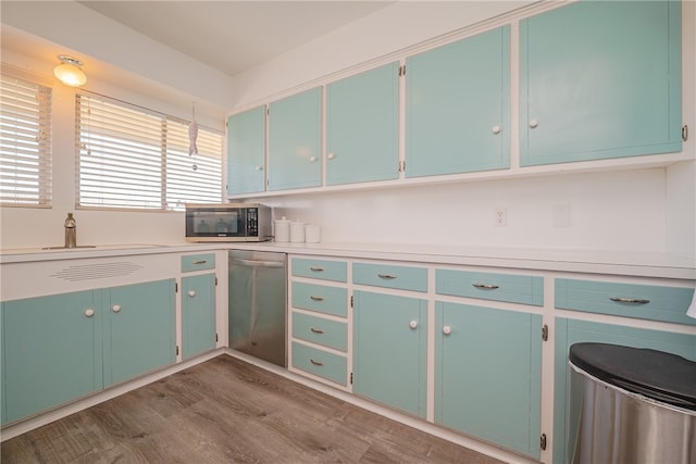 kitchen with sink, wood-type flooring, and stainless steel appliances