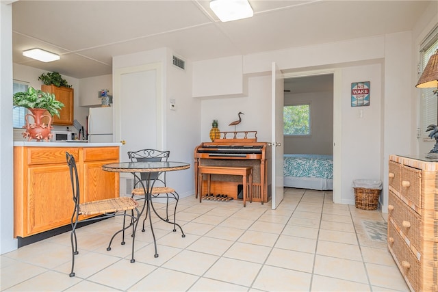 kitchen with white refrigerator and light tile patterned floors