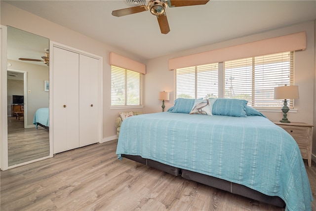 bedroom with hardwood / wood-style floors, ceiling fan, and a closet