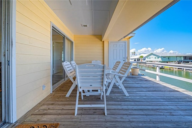 5 Sandpiper Ln, Rockport, TX 78382 - wooden terrace featuring a water view and outdoor dining area