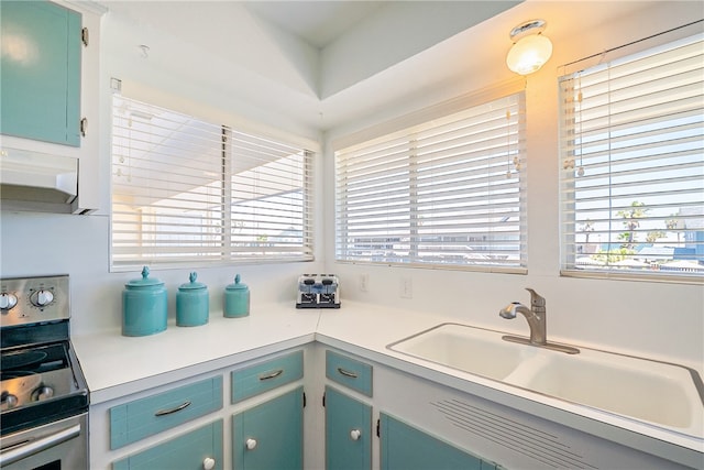 kitchen featuring sink, stainless steel range, and a healthy amount of sunlight