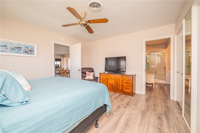 bedroom featuring light hardwood / wood-style floors, ceiling fan, and connected bathroom