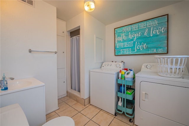 laundry room featuring sink, washing machine and clothes dryer, and light tile patterned floors