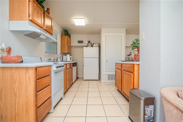 kitchen with white appliances and light tile patterned floors