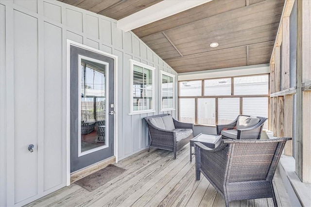 sunroom featuring vaulted ceiling with beams and wood ceiling