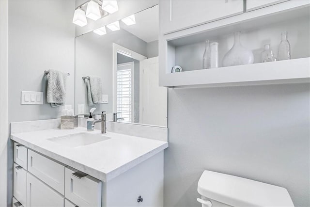 bathroom with vanity and toilet