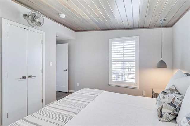 bedroom with a closet and wood ceiling