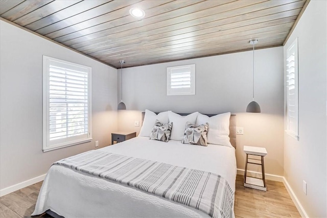 bedroom with light hardwood / wood-style floors and wood ceiling