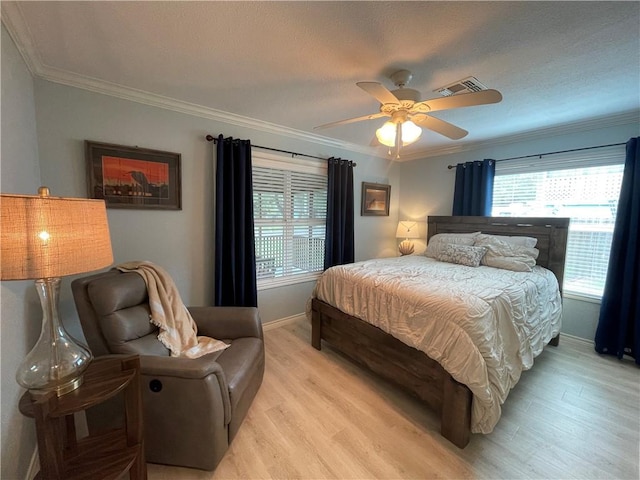 108 Palm St, Rockport, TX 78382 - bedroom featuring light wood finished floors, baseboards, crown molding, and ceiling fan