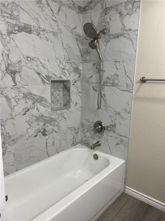 306 Circle Dr, Corpus Christi, TX 78412 - full bathroom featuring  shower combination, wood finished floors, and baseboards