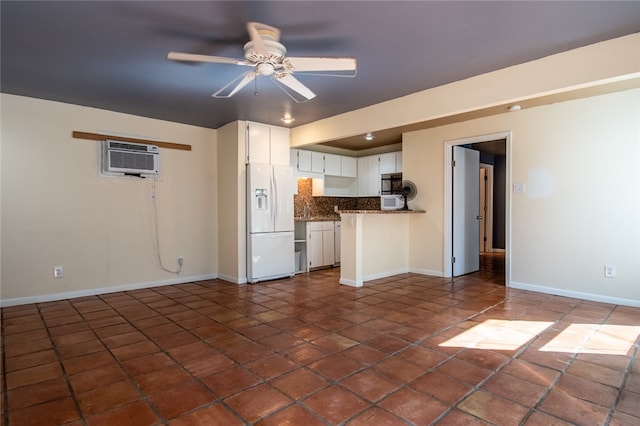 kitchen with ceiling fan, white fridge with ice dispenser, backsplash, white cabinets, and an AC wall unit