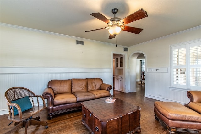 living room with ceiling fan, dark hardwood / wood-style flooring, and ornamental molding