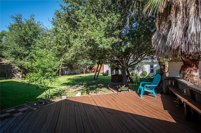 wooden terrace with a lawn