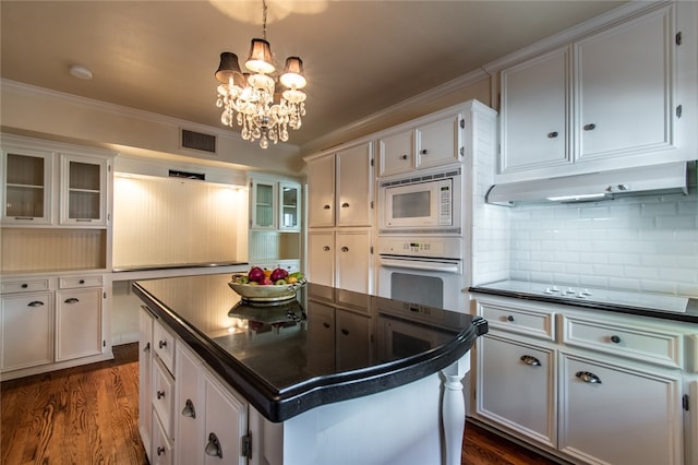 kitchen featuring white cabinets, white appliances, and a kitchen island