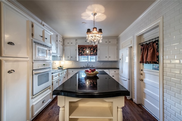 kitchen featuring white cabinetry, white appliances, and a kitchen island