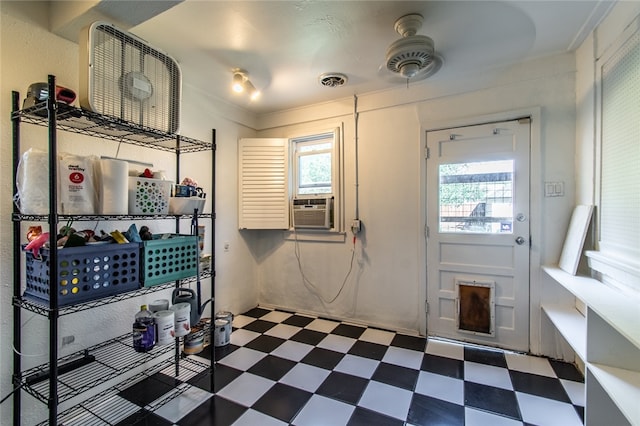 interior space featuring cooling unit and ceiling fan