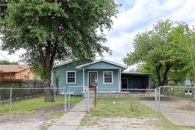 bungalow featuring a gate, covered porch, and a fenced front yard