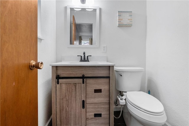 bathroom featuring toilet and vanity