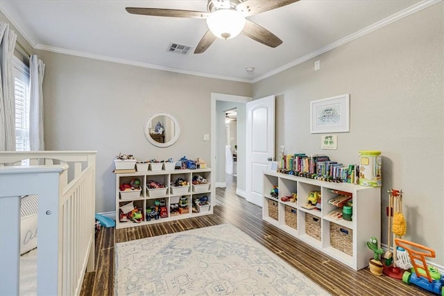 recreation room with crown molding, dark hardwood / wood-style floors, and ceiling fan