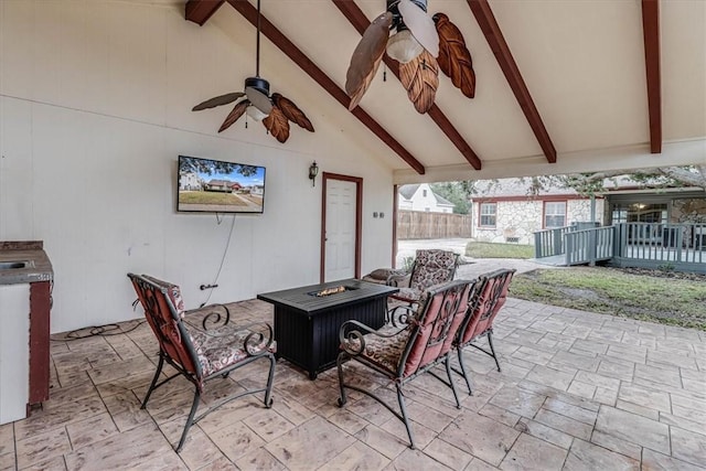 view of patio / terrace with ceiling fan and a fire pit