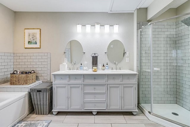 bathroom featuring tasteful backsplash, vanity, and separate shower and tub