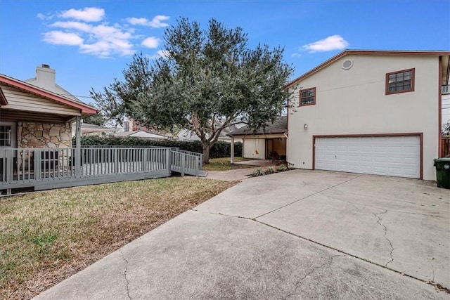 exterior space featuring a garage and a lawn