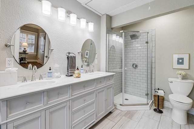 bathroom with vanity, toilet, and a shower with shower door