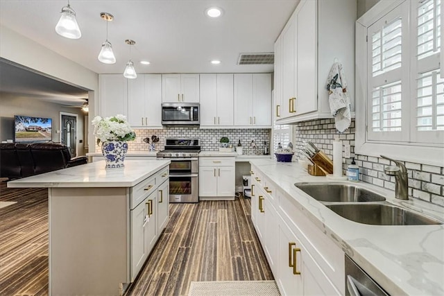 kitchen with white cabinetry, appliances with stainless steel finishes, and sink