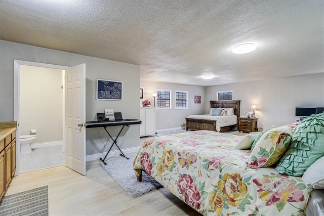 bedroom with light hardwood / wood-style flooring and a textured ceiling