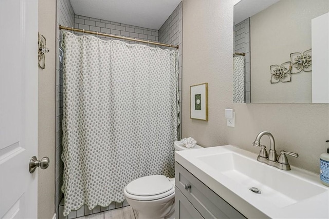 bathroom with vanity, toilet, and a shower with shower curtain