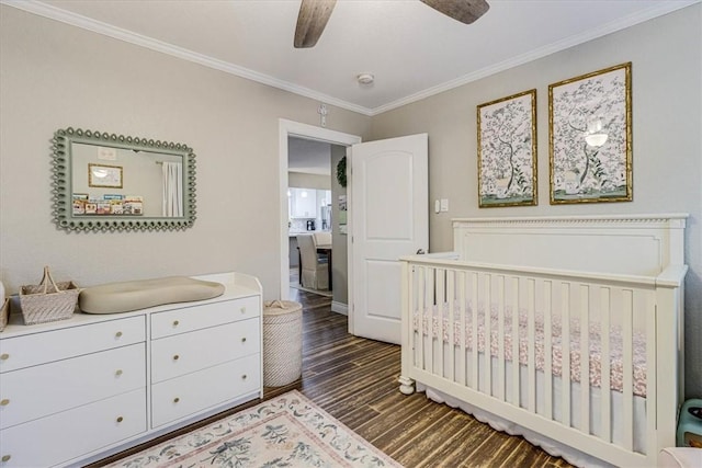 bedroom featuring crown molding, dark wood-type flooring, and ceiling fan