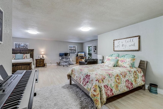 bedroom featuring a textured ceiling and light wood-type flooring