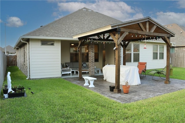 rear view of house with a lawn, a gazebo, and a patio