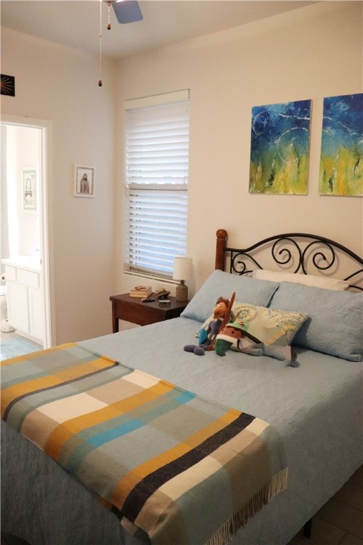 bedroom with ensuite bath and ceiling fan