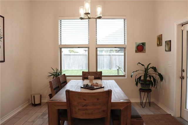 dining space with an inviting chandelier and a healthy amount of sunlight