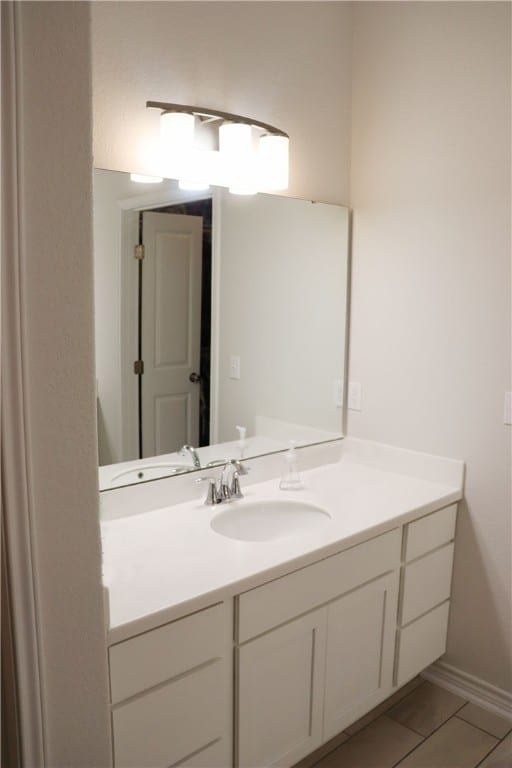 bathroom with tile patterned floors and vanity