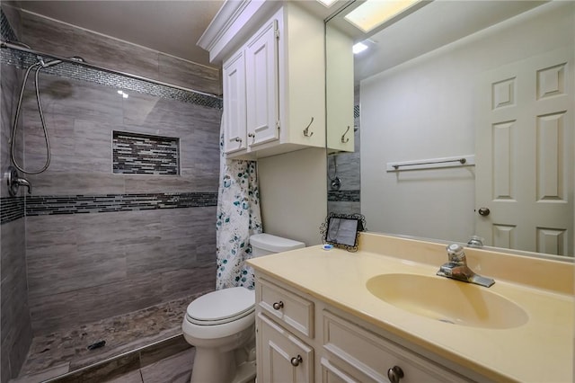 bathroom featuring vanity, curtained shower, and toilet