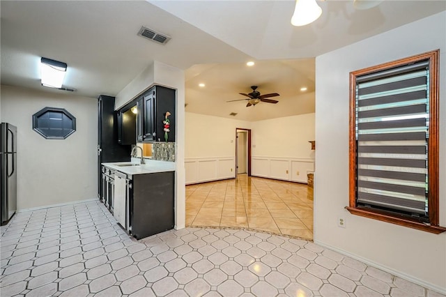 kitchen featuring ceiling fan, sink, and appliances with stainless steel finishes