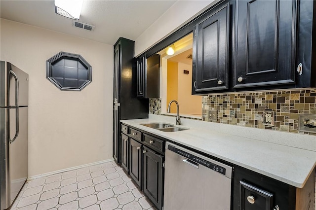 kitchen featuring backsplash, sink, and appliances with stainless steel finishes