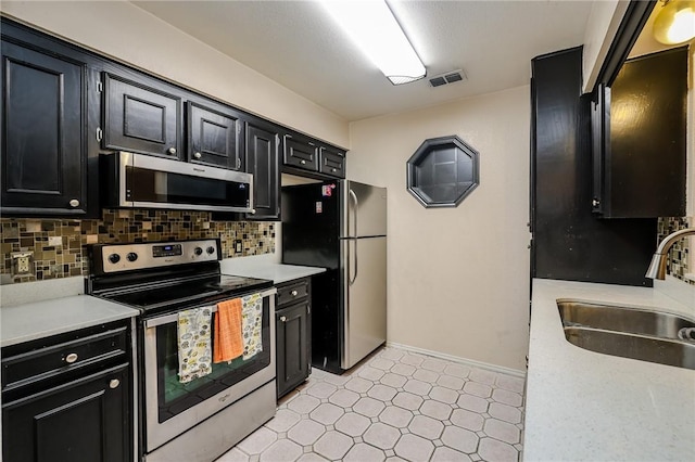 kitchen with backsplash, sink, and stainless steel appliances