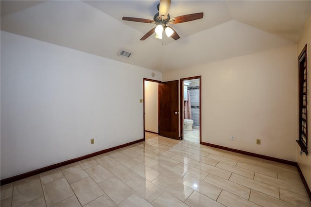 empty room with ceiling fan and vaulted ceiling