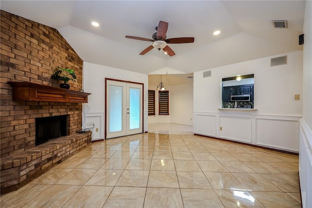 unfurnished living room with ceiling fan, lofted ceiling, and a fireplace