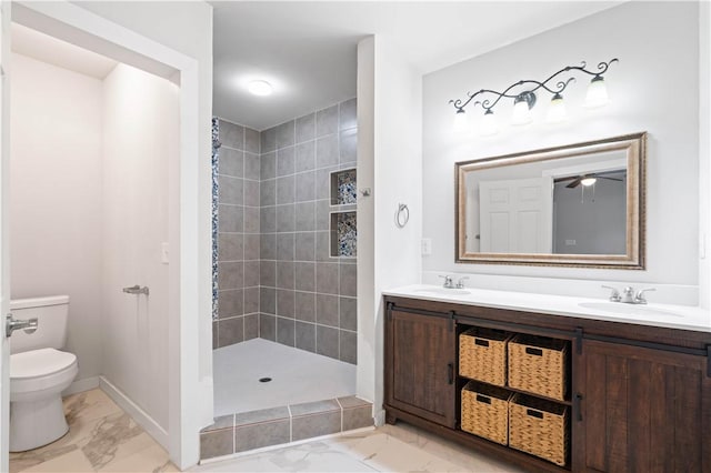 2914 Debra, Corpus Christi, TX 78418 - bathroom with a tile shower, a sink, toilet, and marble finish floor
