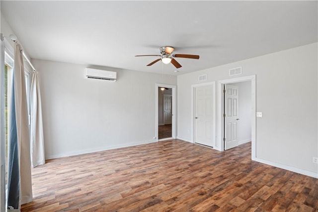 2914 Debra, Corpus Christi, TX 78418 - unfurnished bedroom featuring wood finished floors, visible vents, an AC wall unit, and baseboards